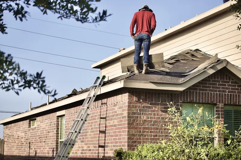 Professional roofer working on a residential roof in Upper Mill